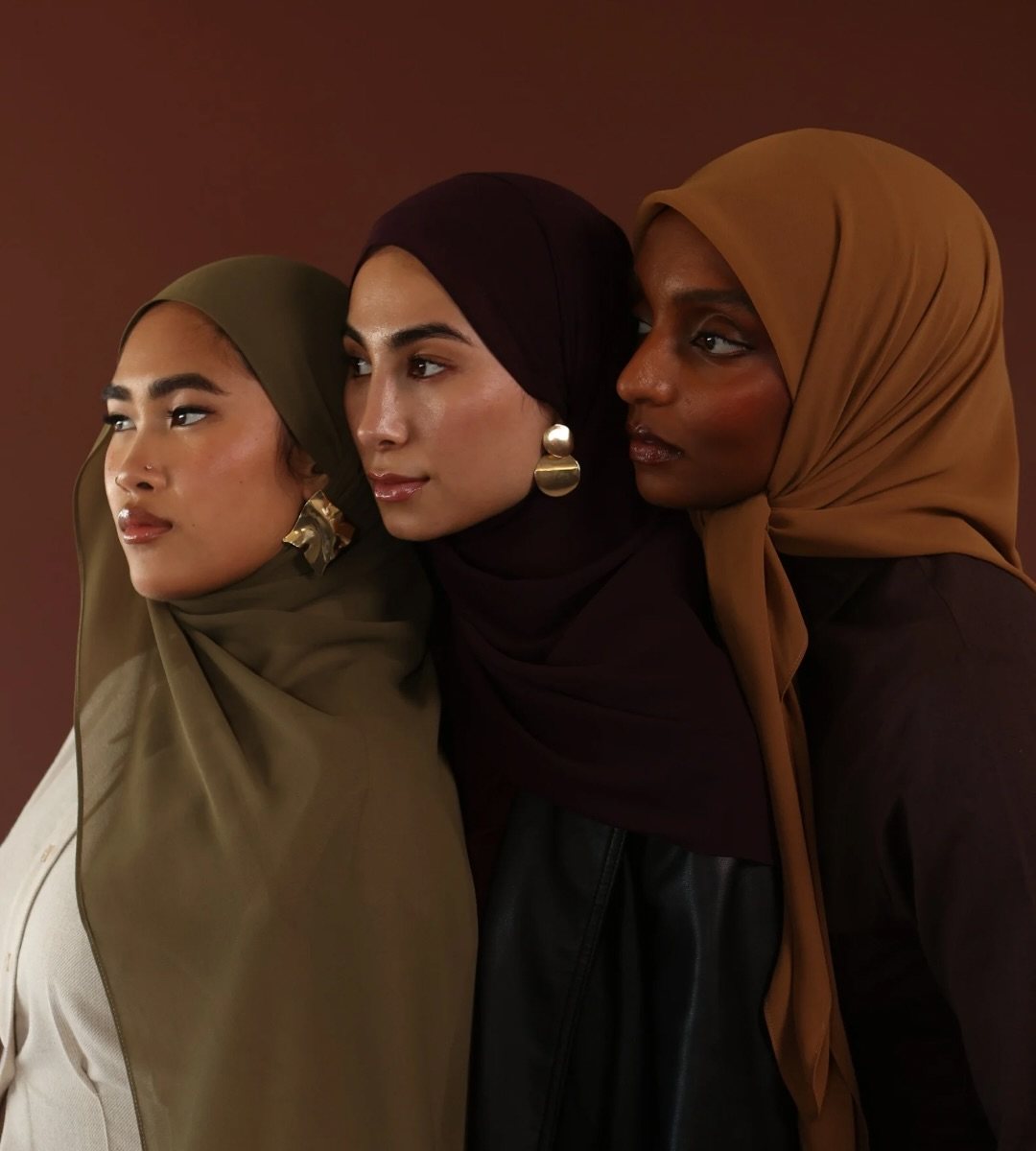 Three women wearing tuck-in hijabs